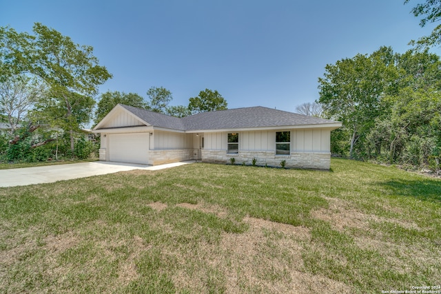 ranch-style home with a garage and a front yard