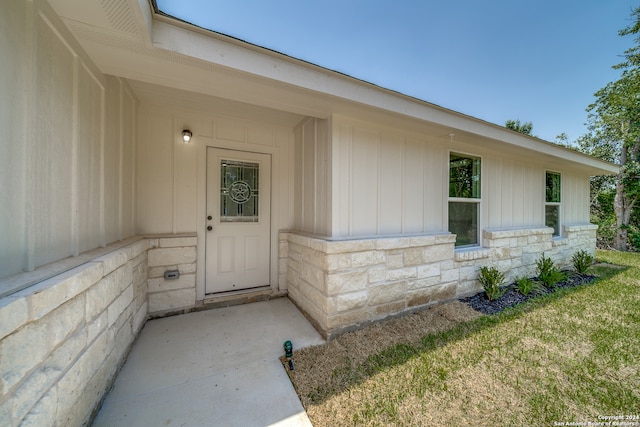 doorway to property featuring a yard