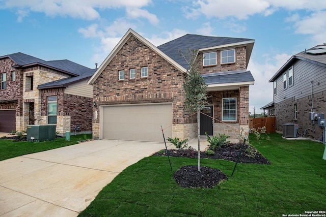 craftsman-style home featuring central AC, a garage, and a front lawn