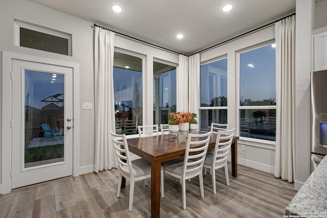 dining space with light hardwood / wood-style floors