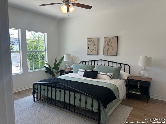 bedroom with hardwood / wood-style flooring and ceiling fan