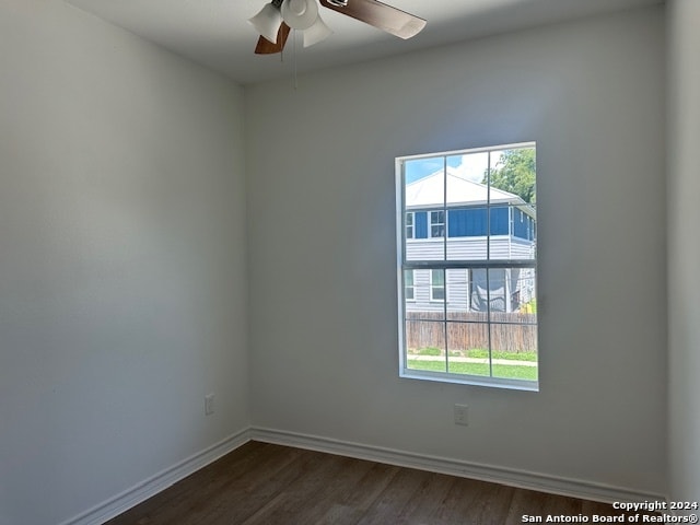 spare room with hardwood / wood-style flooring and ceiling fan