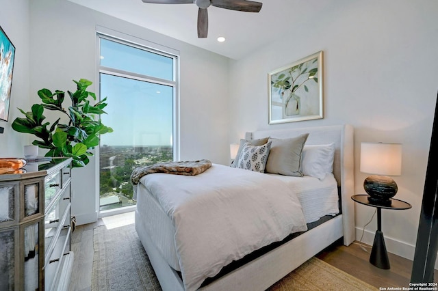 bedroom with ceiling fan and light hardwood / wood-style flooring