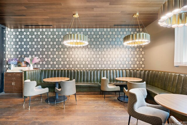 dining room with hardwood / wood-style flooring and wooden ceiling