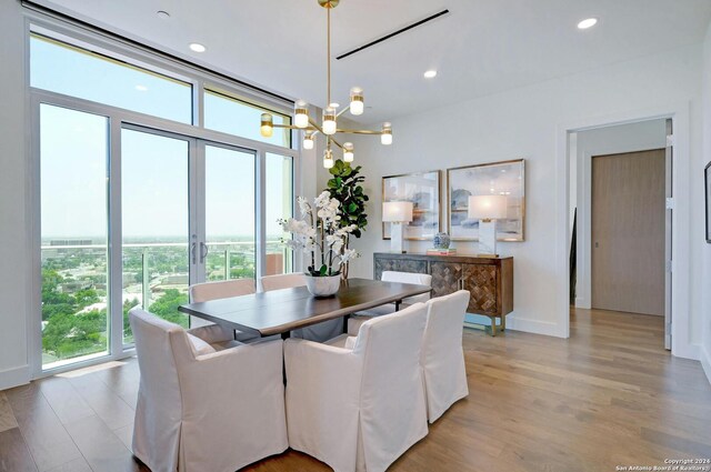 dining room featuring light hardwood / wood-style floors and a notable chandelier