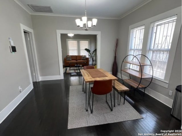 dining space featuring plenty of natural light, crown molding, dark hardwood / wood-style floors, and a chandelier