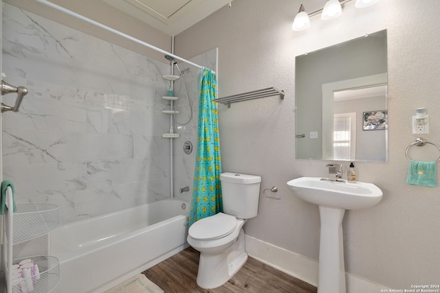 bathroom featuring shower / bath combo with shower curtain, wood-type flooring, and toilet