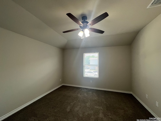 spare room featuring ceiling fan, lofted ceiling, and carpet flooring