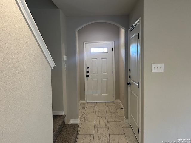 doorway to outside featuring light tile patterned floors