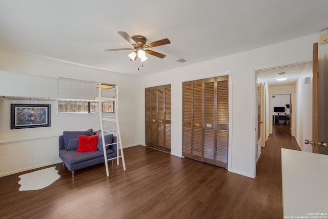 sitting room with ceiling fan and dark hardwood / wood-style flooring