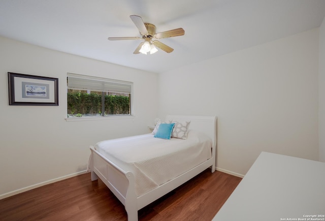 bedroom featuring ceiling fan and dark hardwood / wood-style floors