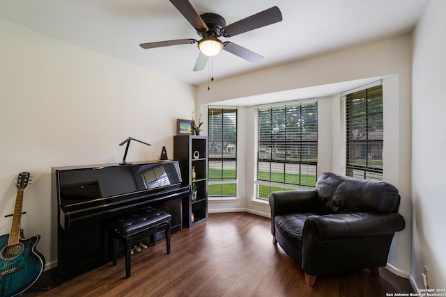 living area with ceiling fan and dark hardwood / wood-style floors