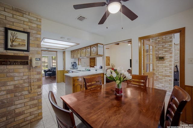 dining space featuring light tile patterned flooring and sink