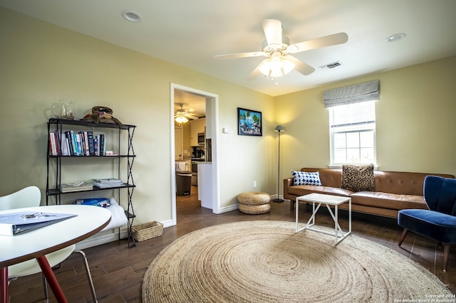 living area with dark wood-type flooring and ceiling fan