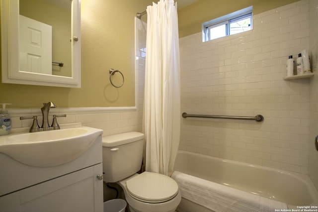 full bathroom featuring tile walls, toilet, vanity, and shower / tub combo with curtain