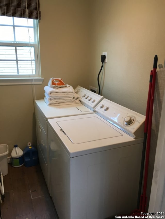 laundry room with independent washer and dryer and dark hardwood / wood-style flooring