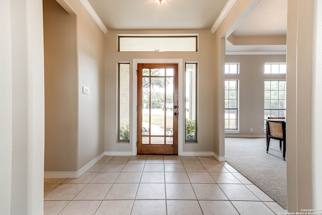 entrance foyer with crown molding and light tile patterned flooring