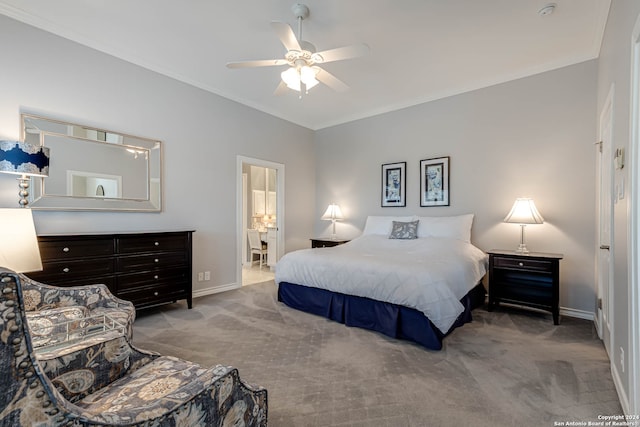 carpeted bedroom featuring ensuite bath, ornamental molding, and ceiling fan