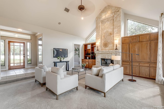 24434 Blanco Rd, San Antonio, TX 78260 - living area featuring a fireplace, a healthy amount of sunlight, light colored carpet, and high vaulted ceiling