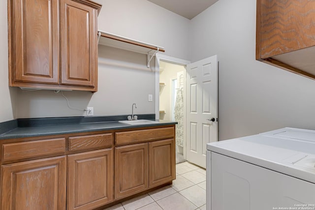 24434 Blanco Rd, San Antonio, TX 78260 - washroom with washer and clothes dryer, cabinet space, light tile patterned flooring, and a sink