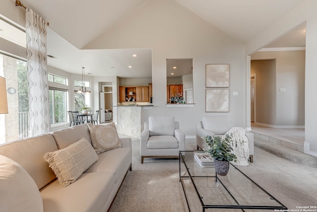 living room with light carpet and high vaulted ceiling