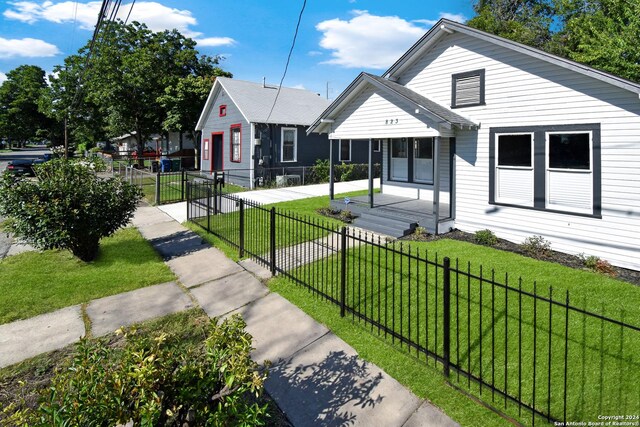 bungalow-style house featuring a front yard