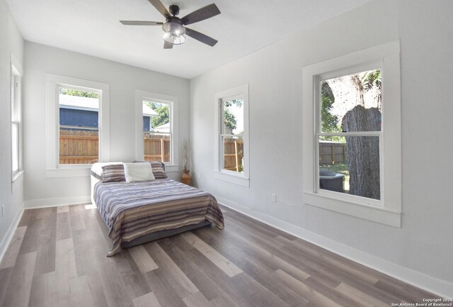 bedroom with ceiling fan and hardwood / wood-style floors