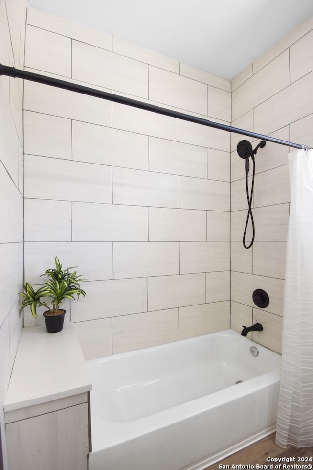 bathroom with shower / bath combo with shower curtain