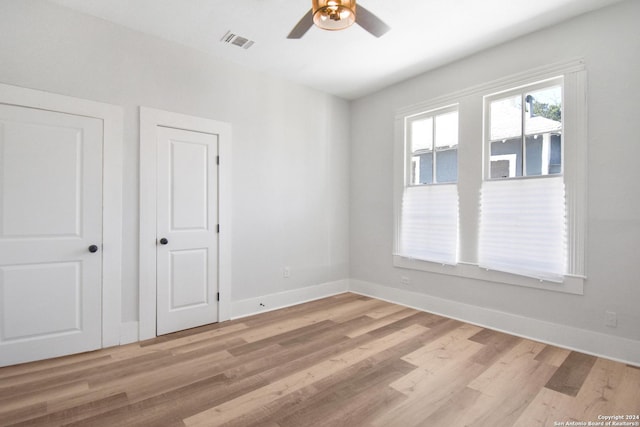 spare room with ceiling fan and light hardwood / wood-style floors