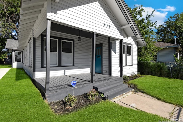 doorway to property featuring a lawn