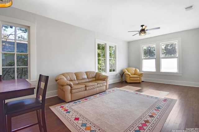 living room with dark hardwood / wood-style floors and ceiling fan