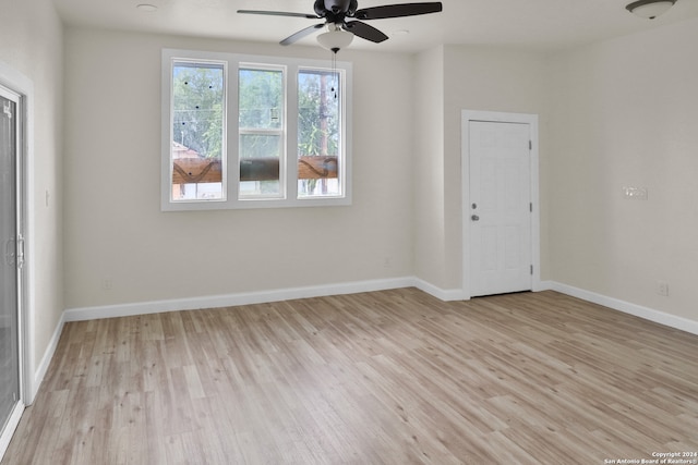 spare room featuring light wood-type flooring and ceiling fan