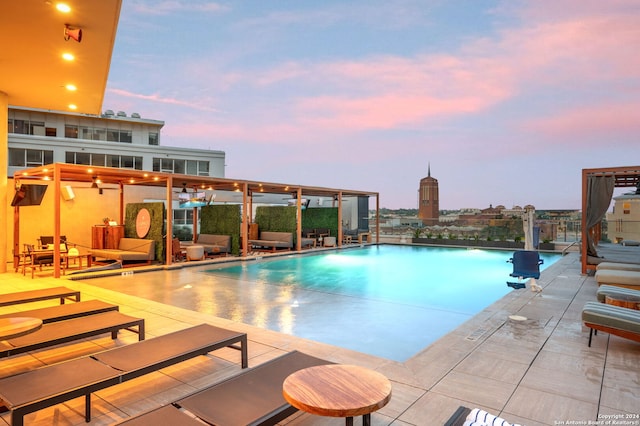 pool at dusk with a patio