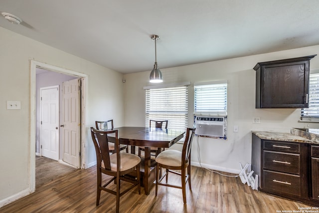 dining space featuring a healthy amount of sunlight, hardwood / wood-style floors, and cooling unit