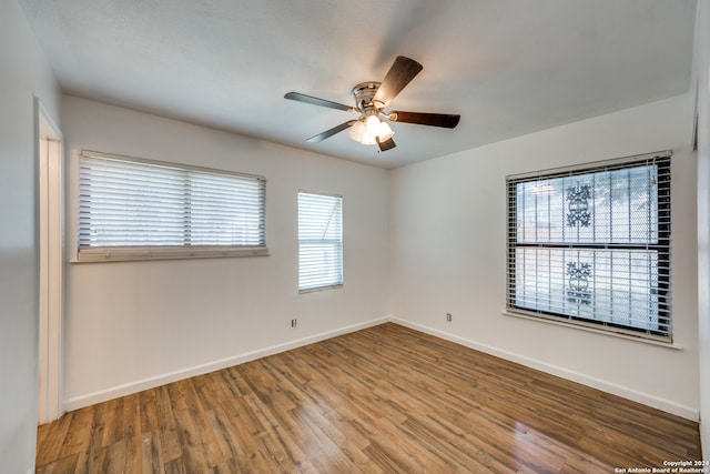 unfurnished room featuring hardwood / wood-style floors and ceiling fan