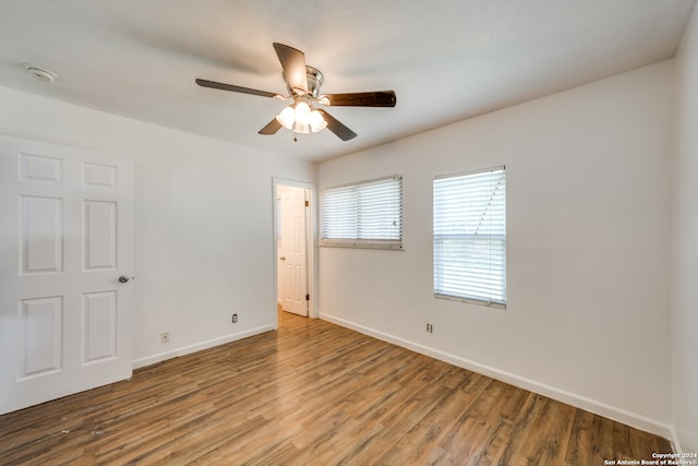 spare room featuring ceiling fan and hardwood / wood-style flooring