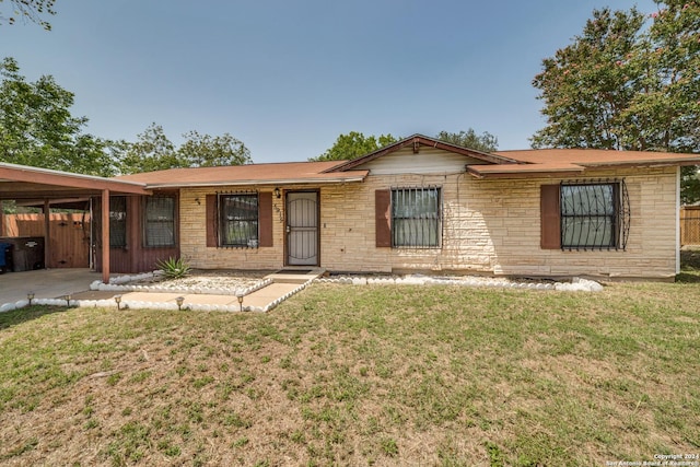 single story home with stone siding, fence, and a front yard