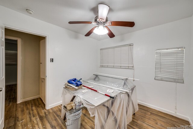 bedroom with ceiling fan and dark hardwood / wood-style flooring