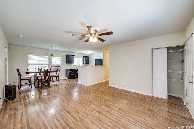 living room featuring ceiling fan and wood-type flooring