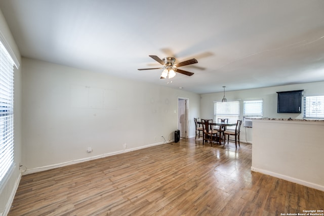 unfurnished living room featuring light wood-type flooring and ceiling fan