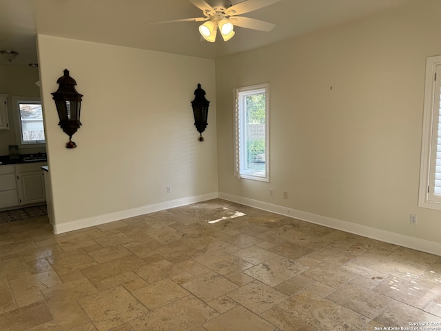 unfurnished room with ceiling fan