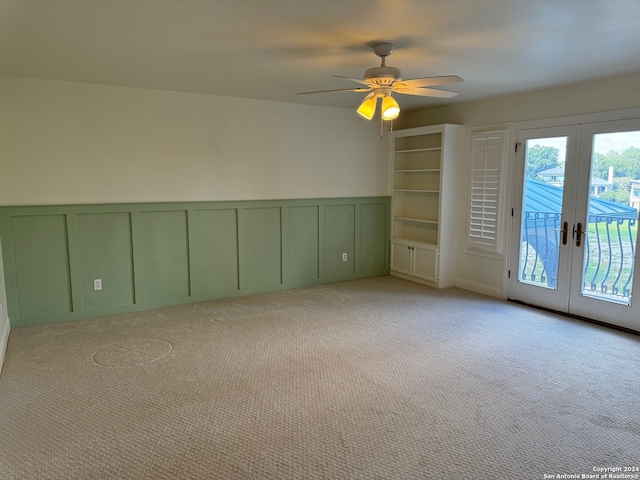 carpeted empty room featuring ceiling fan and french doors