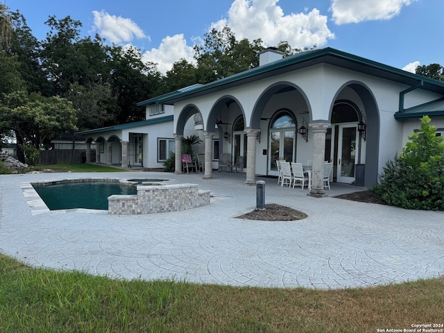 rear view of house with french doors and a patio