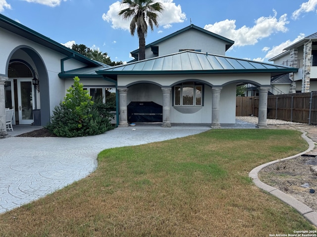 rear view of property featuring a yard