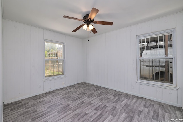 empty room featuring ceiling fan and light hardwood / wood-style flooring