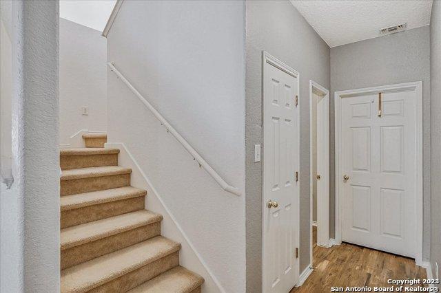 stairway with hardwood / wood-style floors