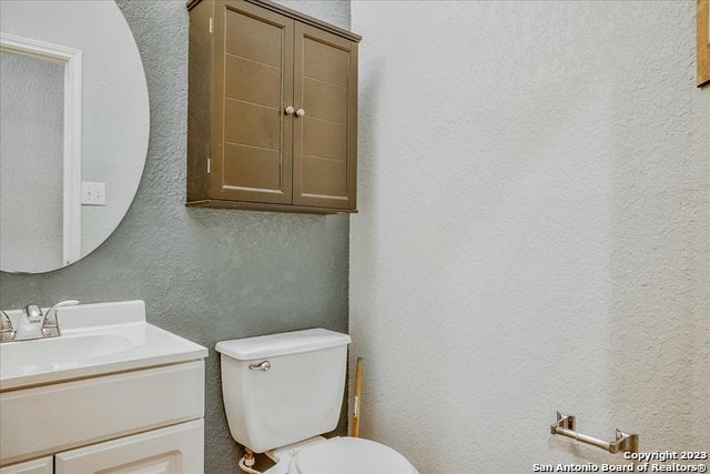 bathroom with toilet and vanity