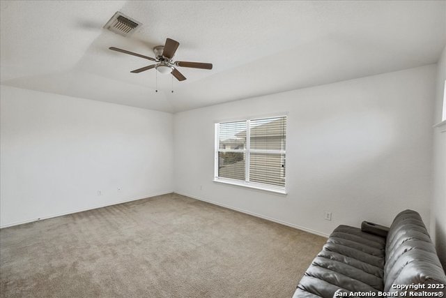 unfurnished living room featuring carpet and ceiling fan