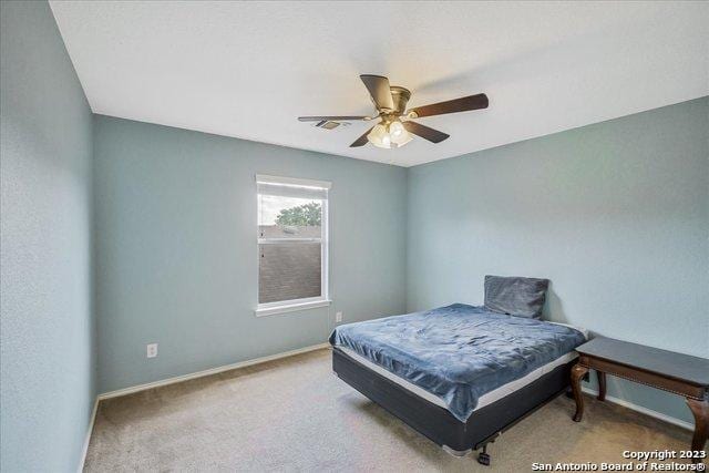 bedroom featuring light carpet and ceiling fan