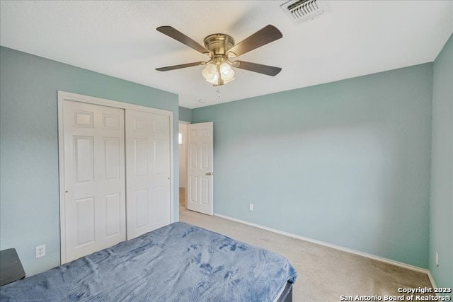 unfurnished bedroom with a closet, carpet, and ceiling fan